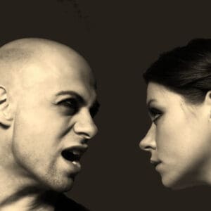 A tense confrontation between a bald man and a woman staring intensely.