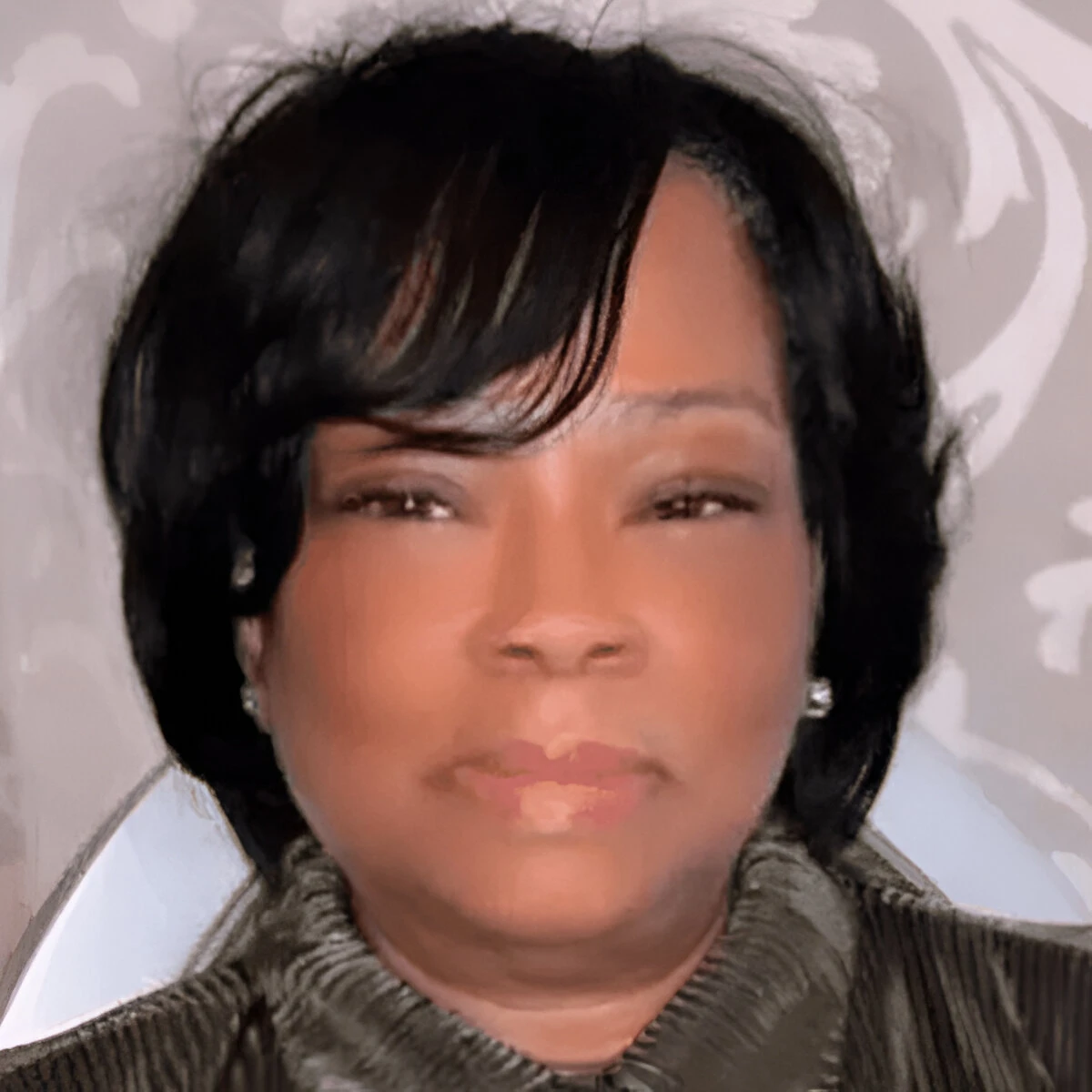 Portrait of a woman with short black hair and a neutral expression.